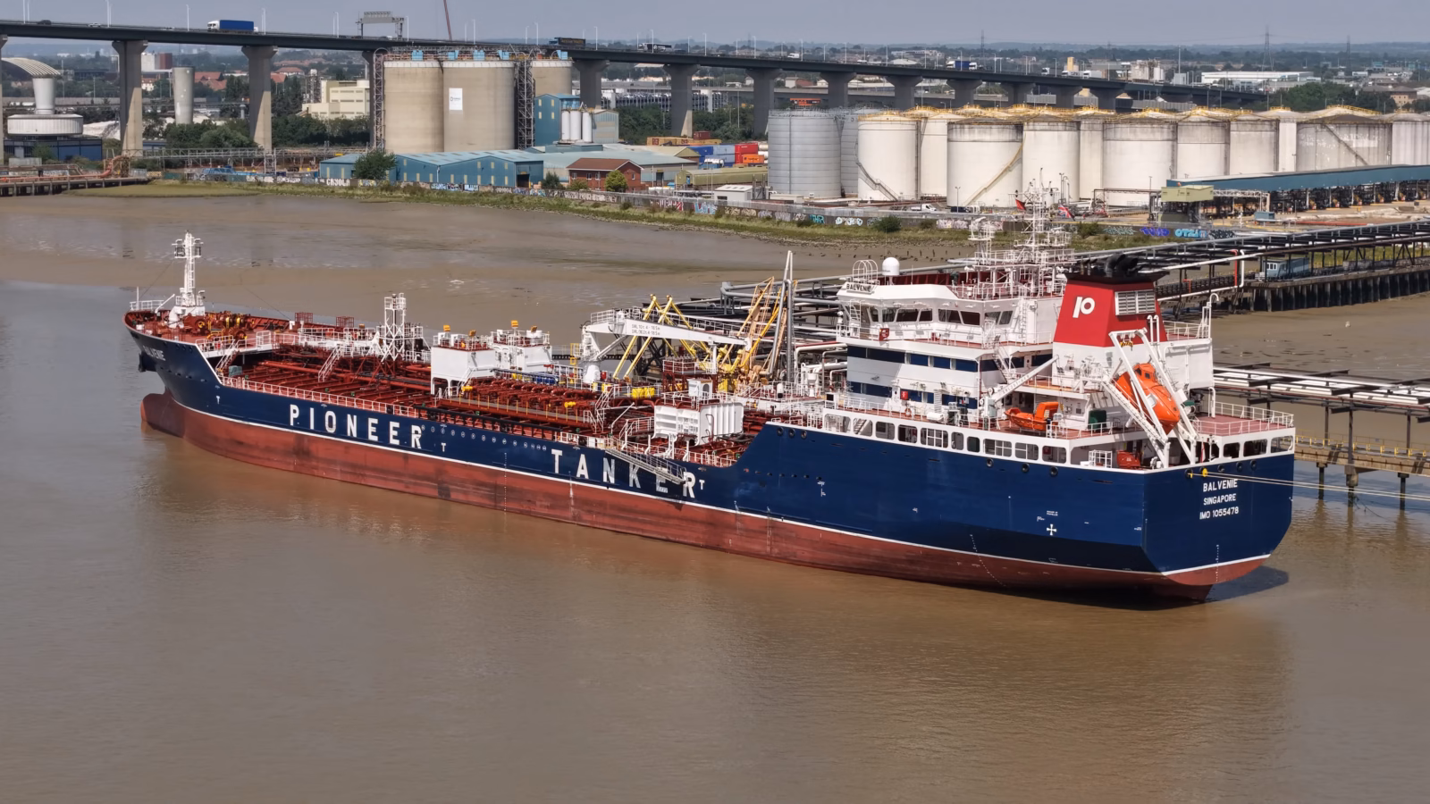 Aerial broadside view of the tanker Balvenie at a Thames oil terminal, with the jetty gantry and shore tank farm behind