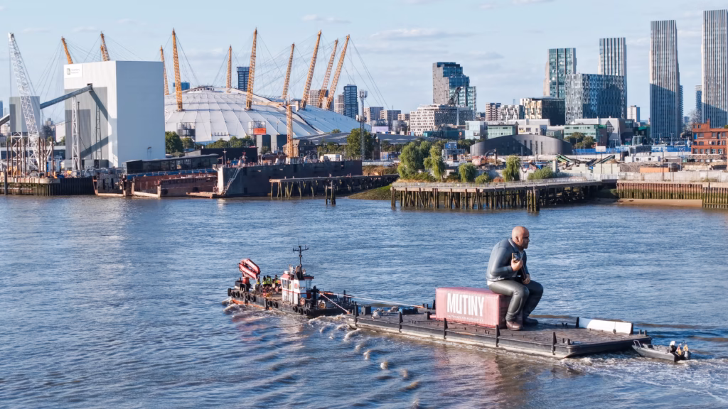 Mutiny: Jason Statham Brand Activation on the Thames 9 The Damen multicat Emilia D towing the Mutiny pontoon through Bugsby's Reach on the tidal Thames, with a safety boat in attendance