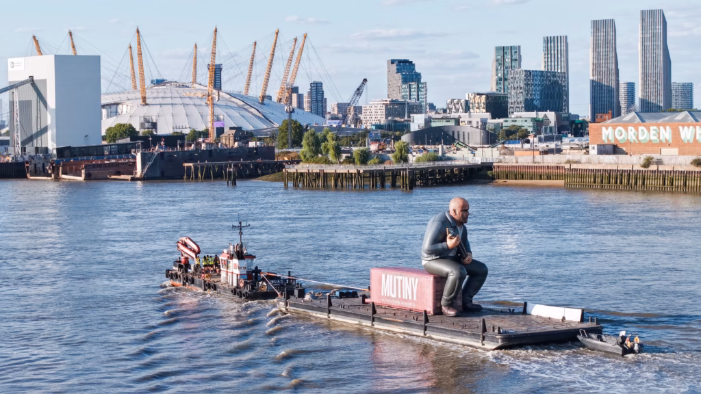Mutiny: Jason Statham Brand Activation on the Thames 8 Close aerial photograph of the Mutiny shipping container marked 'In theaters August 21' with the giant Jason Statham inflatable seated on top
