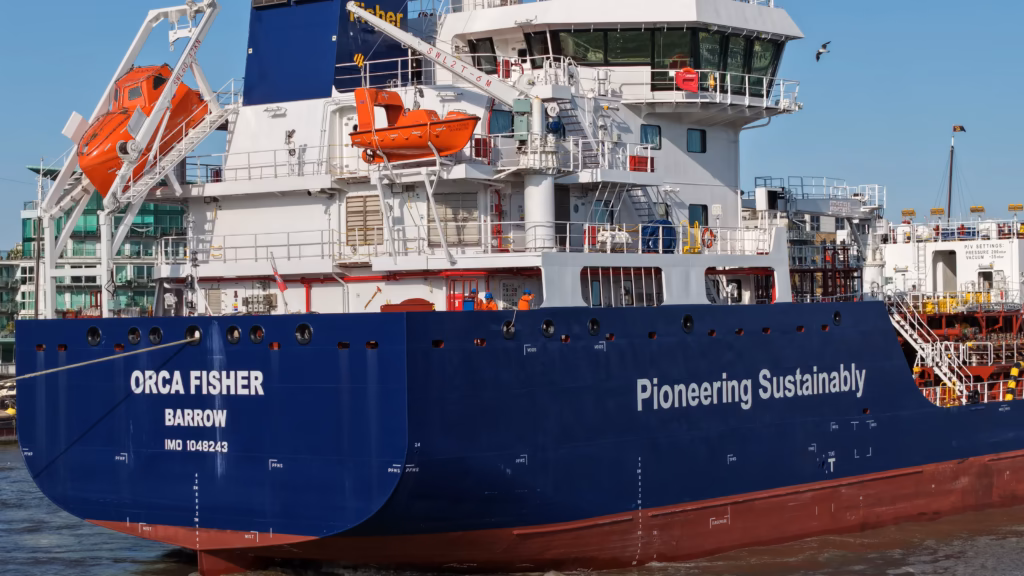 The James Fisher tanker Orca Fisher of Barrow under way on the River Thames, crew on deck forward of the accommodation