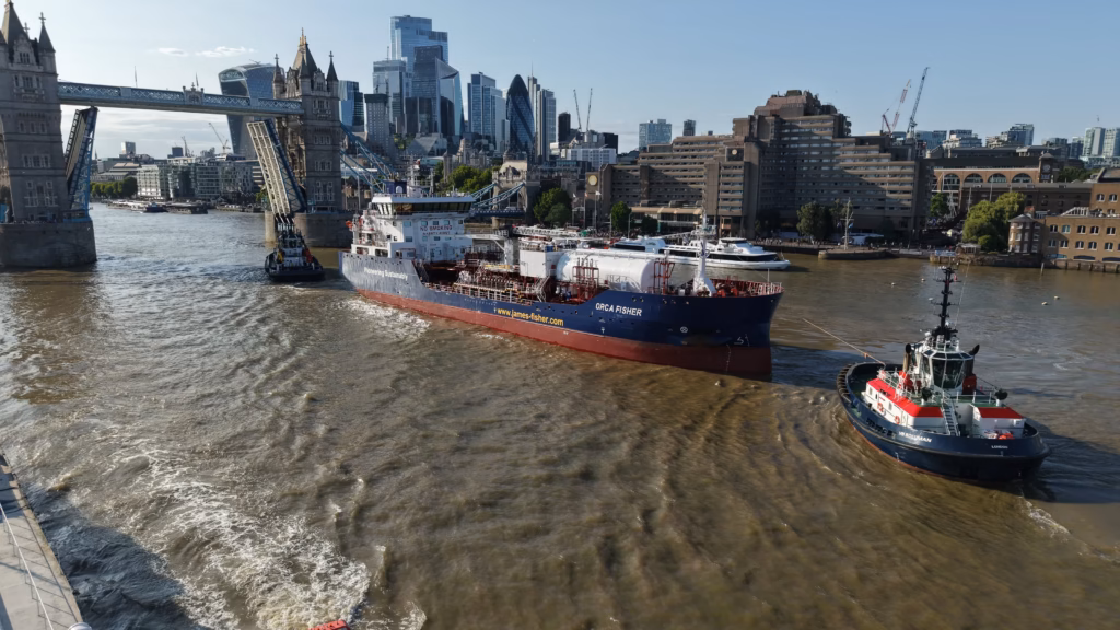 The Orca Fisher passing through Tower Bridge on the River Thames with Boluda tugs in attendance