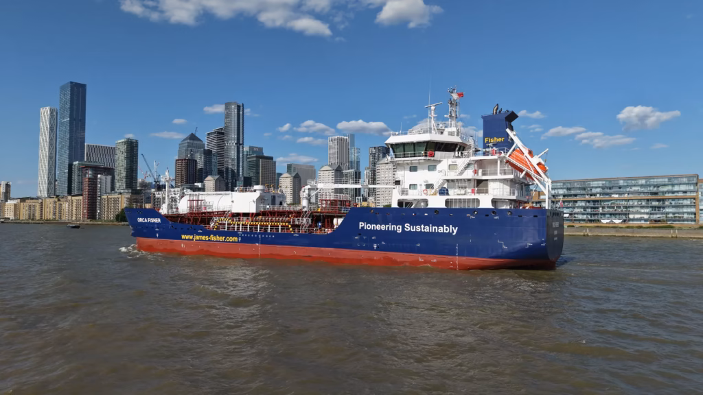 Close aerial view of the James Fisher tanker Orca Fisher with One Canada Square and Canary Wharf behind