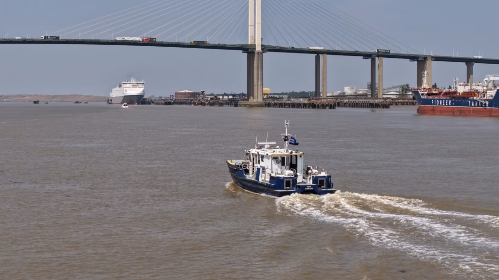 PLA harbour service launch Kew underway on the tidal River Thames at the Dartford Crossing