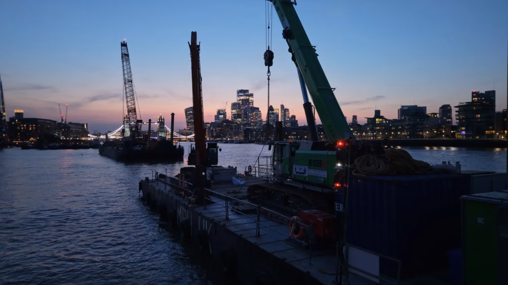 MPH UK spud-leg pontoon jacked up on the River Thames at twilight, aerial drone photograph