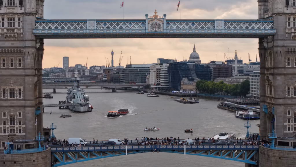 Aerial photograph framing the City of London through Tower Bridge's high-level walkways