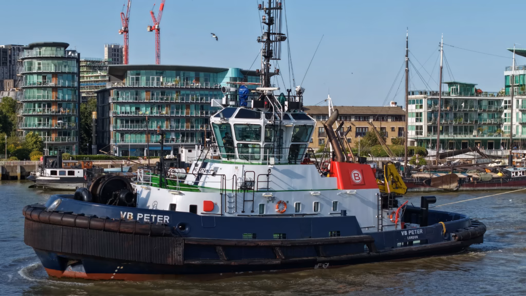 The Boluda tug VB Peter on the River Thames, broadside, with the towing winch and fendering clearly visible