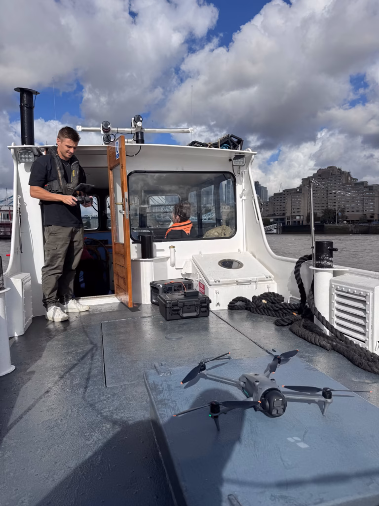 Drone ready for take-off on the stern hatch of a boat on the Thames below Tower Bridge